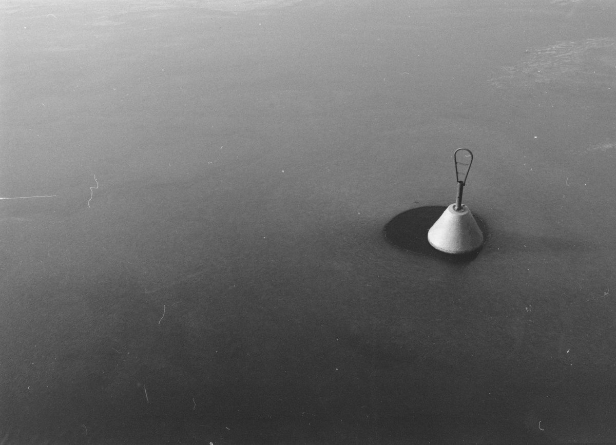 A buoy surrounded by ice.
